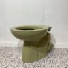 Avocado low level toilet pan P trap with white backdrop and bathroom tiles