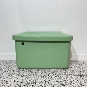 jade green toilet cistern low level on white back drop with bathroom tiles