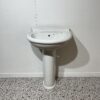 white traditional style basin and pedestal with white backdrop and bathroom tiles